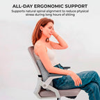 Woman sitting in an office chair using the Cloud Grey lumbar cushion, demonstrating natural spinal alignment and all-day support by Marnify